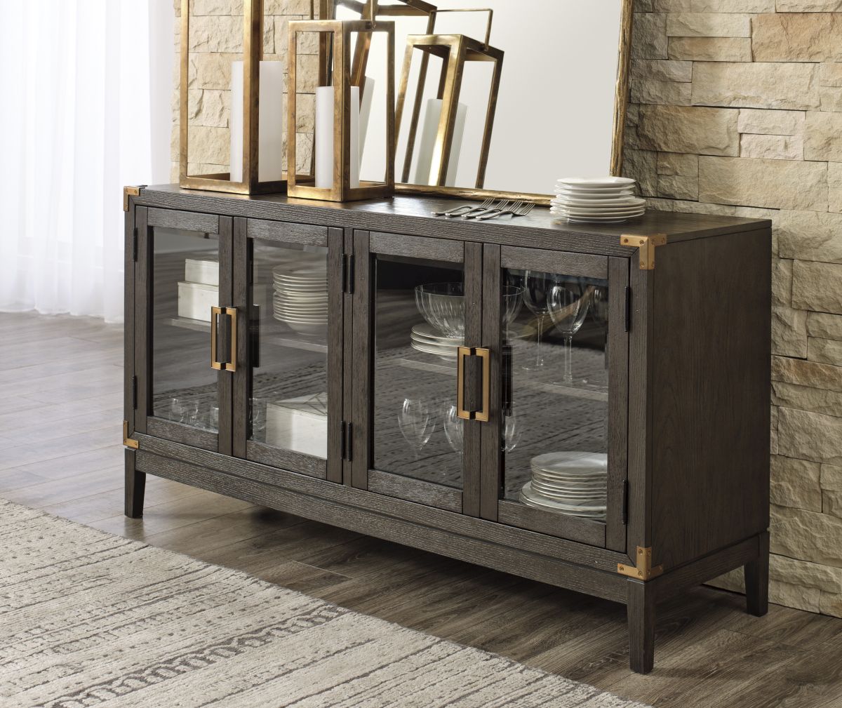 front view of a modern wooden sideboard with glass doors showing dinnerware inside and dinnerware and decor on top